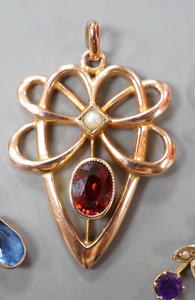 Three assorted early 20th century yellow metal and gem set pendants, including 9ct garnet and split pearl, largest overall 39mm, gross weight 5.2 grams.